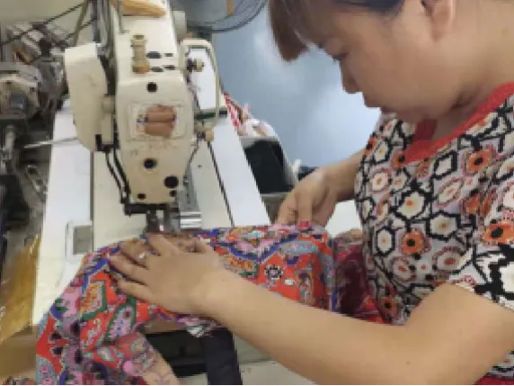 The technician is checking the fabric tucks to make sure exactly same as paper pattern  in production