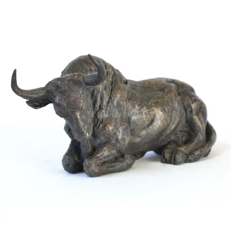 Бронзовый бык в натуральную величину на коленях на земле статуя