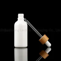 Bouteille d'huile essentielle d'emballage cosmétique en verre de porcelaine blanche de vente chaude