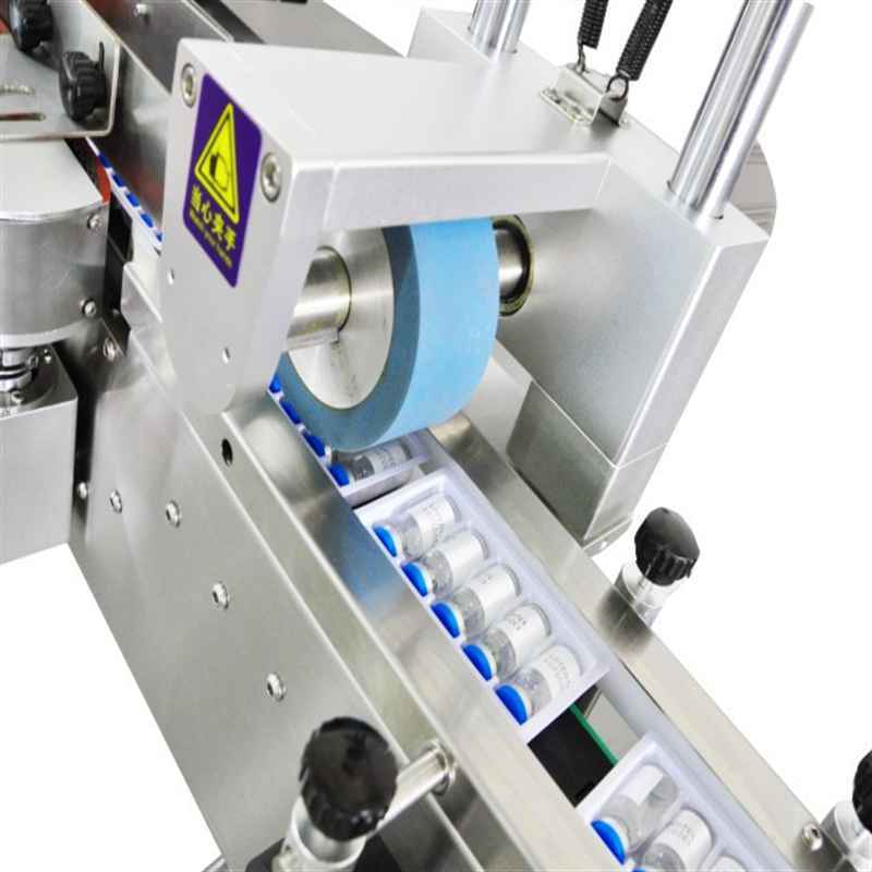 High speed oral liquid vial labeling tray loading packing