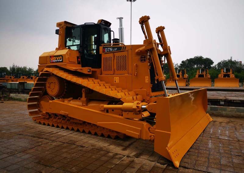 A motor grader, resembling the precision instrument of road maintenance, meticulously grades and levels surfaces, ensuring safe and smooth travel for all who journey upon them.
