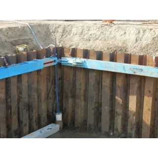 Sheet pile walls are constructed by driving prefabricated sections into the ground.