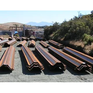 Steel sheet piles are long structural sections with a vertical interlocking system that can form a continuous wall. The walls are typically used to retain soil or water.