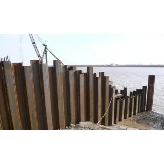 A steel sheet pile is a rolled structural steel profile with interlocking devices on the flange tips that allow the profiles to be joined to form a continuous wall.