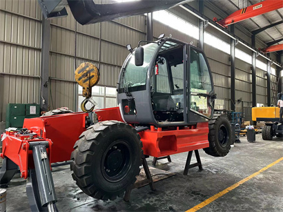 busy workshop with full of forklift and telehandler