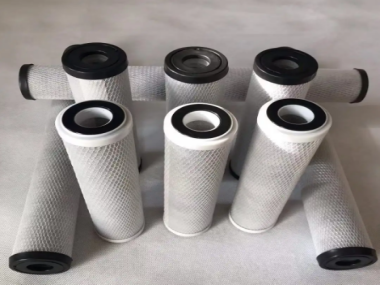 What are the uses of activated carbon at different levels in water purification filters?