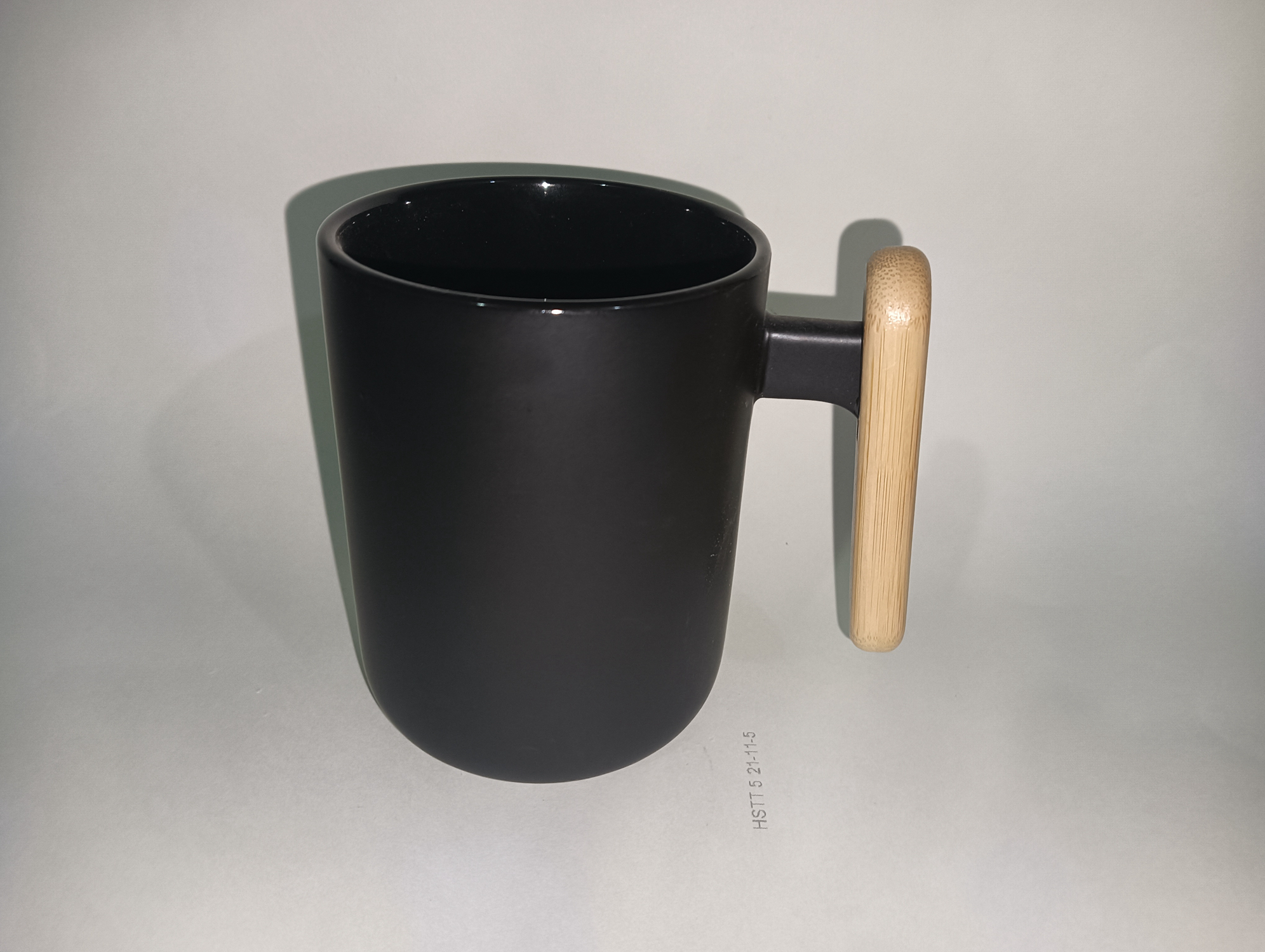 Ceramic cup with wooden handle