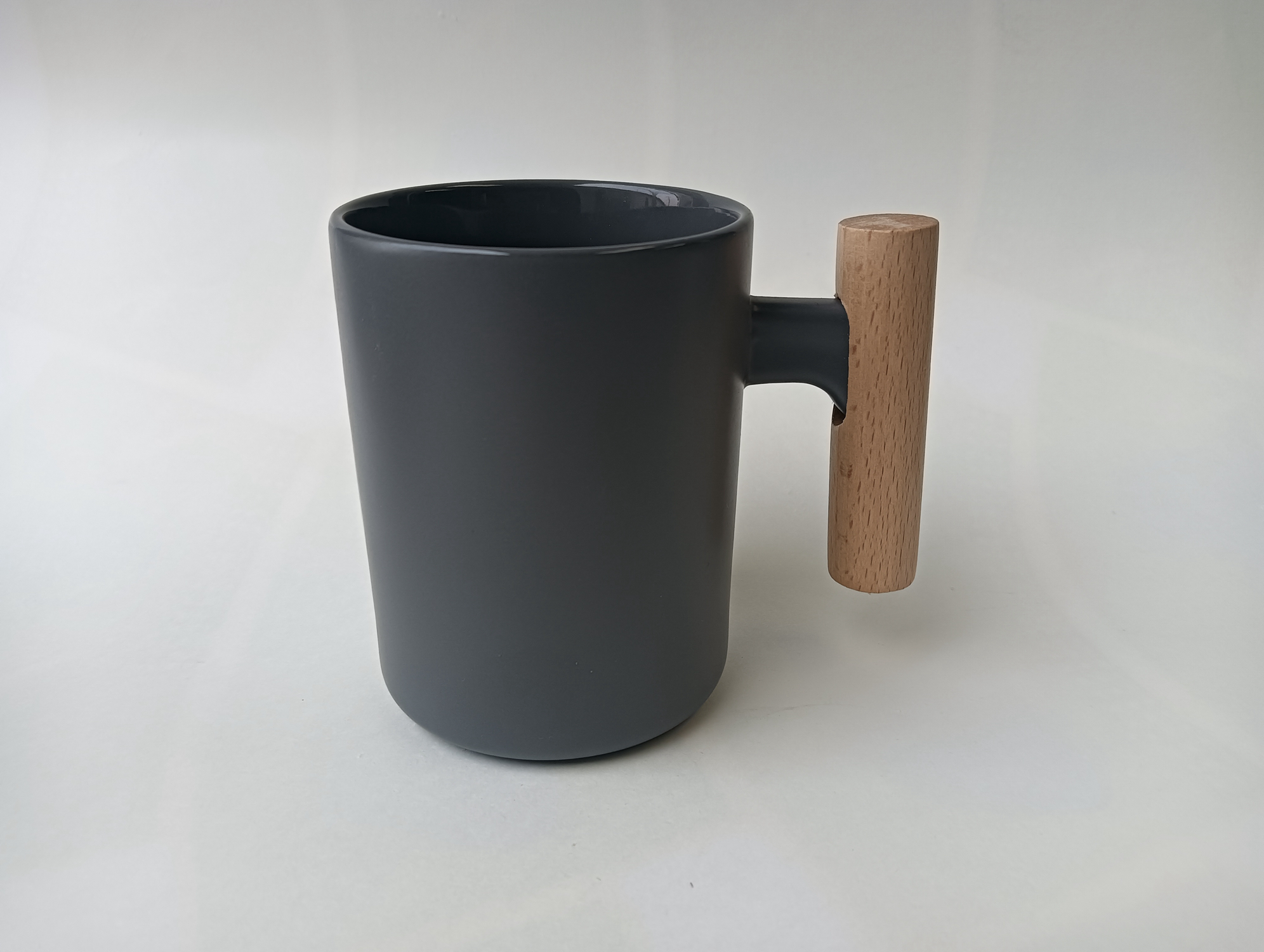 Ceramic cup with wooden handle