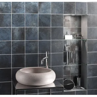 Grey mosaic tiles are understated and luxurious, creating an industrial effect.